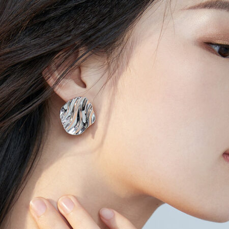 Minimalist Sterling Silver Earrings, with serene ocean-inspired ripple design, evoke a sense of tranquility and ease